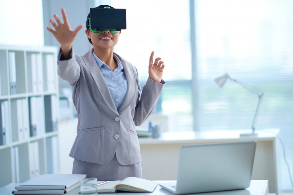 A professional woman in a suit using virtual reality headset in an office setting.