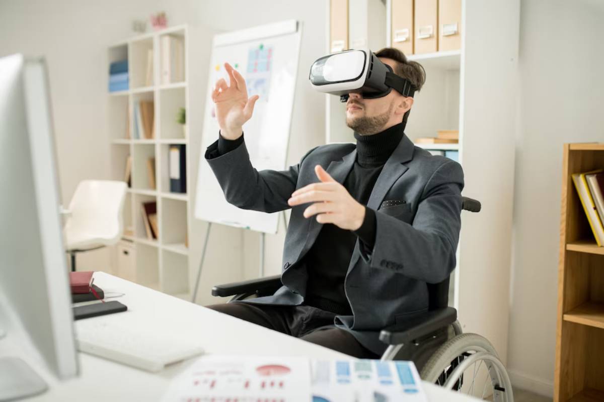 Businessman in a wheelchair using virtual reality headset in an office setting.