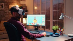 Man wearing virtual reality headset at a desk with a computer screen displaying a graphic design project.