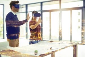 Man and woman using virtual reality headsets in a bright office, interacting with digital overlays of cityscapes.