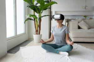 Woman in casual clothing meditating on a mat with a VR headset in a modern living room.